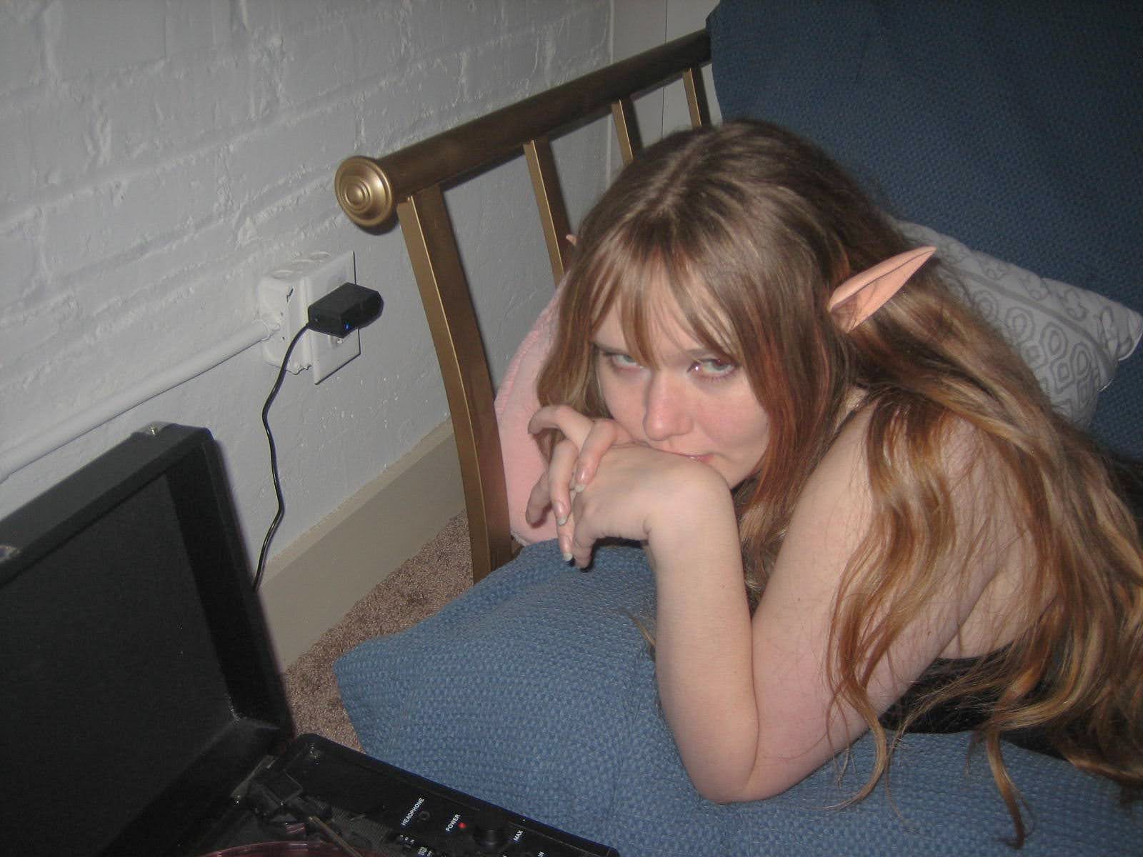 Woman laying on couch with elf ears.